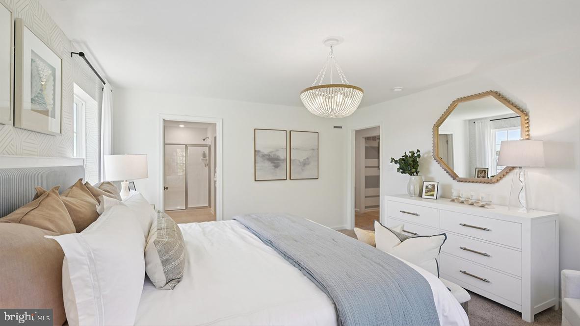 505 Scotty Boulevard, Unit 1302 Rio Grande, NJ 08242 - Photo 30 of 55 a bedroom with a bed and a mirror