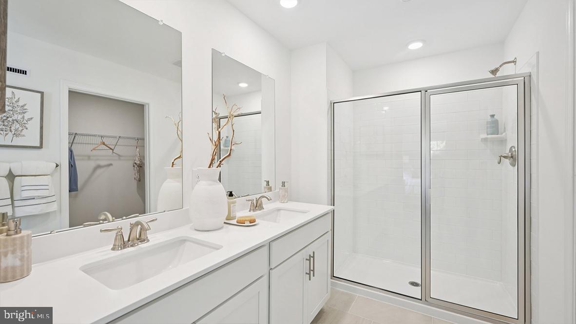 505 Scotty Boulevard, Unit 1302 Rio Grande, NJ 08242 - Photo 32 of 55 a bathroom with a double vanity sink mirror and double