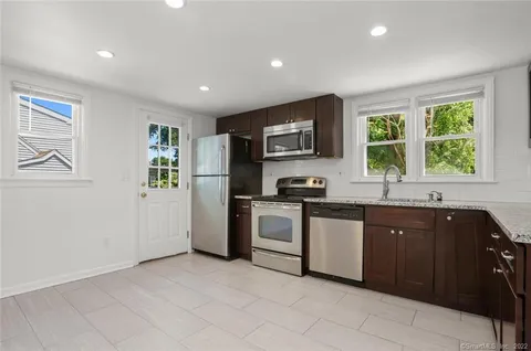 a kitchen with a sink stove and refrigerator
