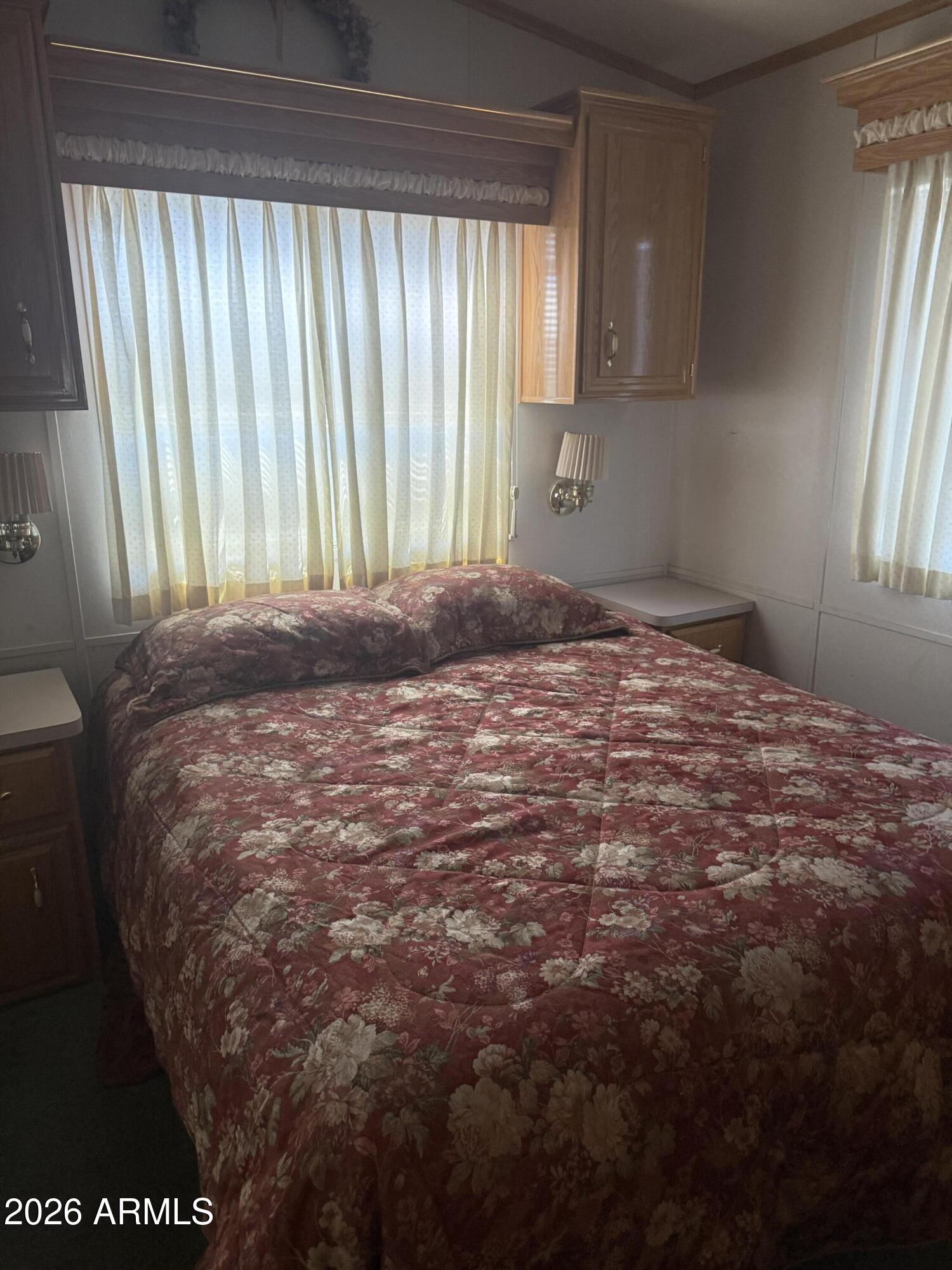 7750 East Broadway Road, Unit 406 Mesa, AZ 85208 - Photo 11 of 36 a bedroom with a bed and a window
