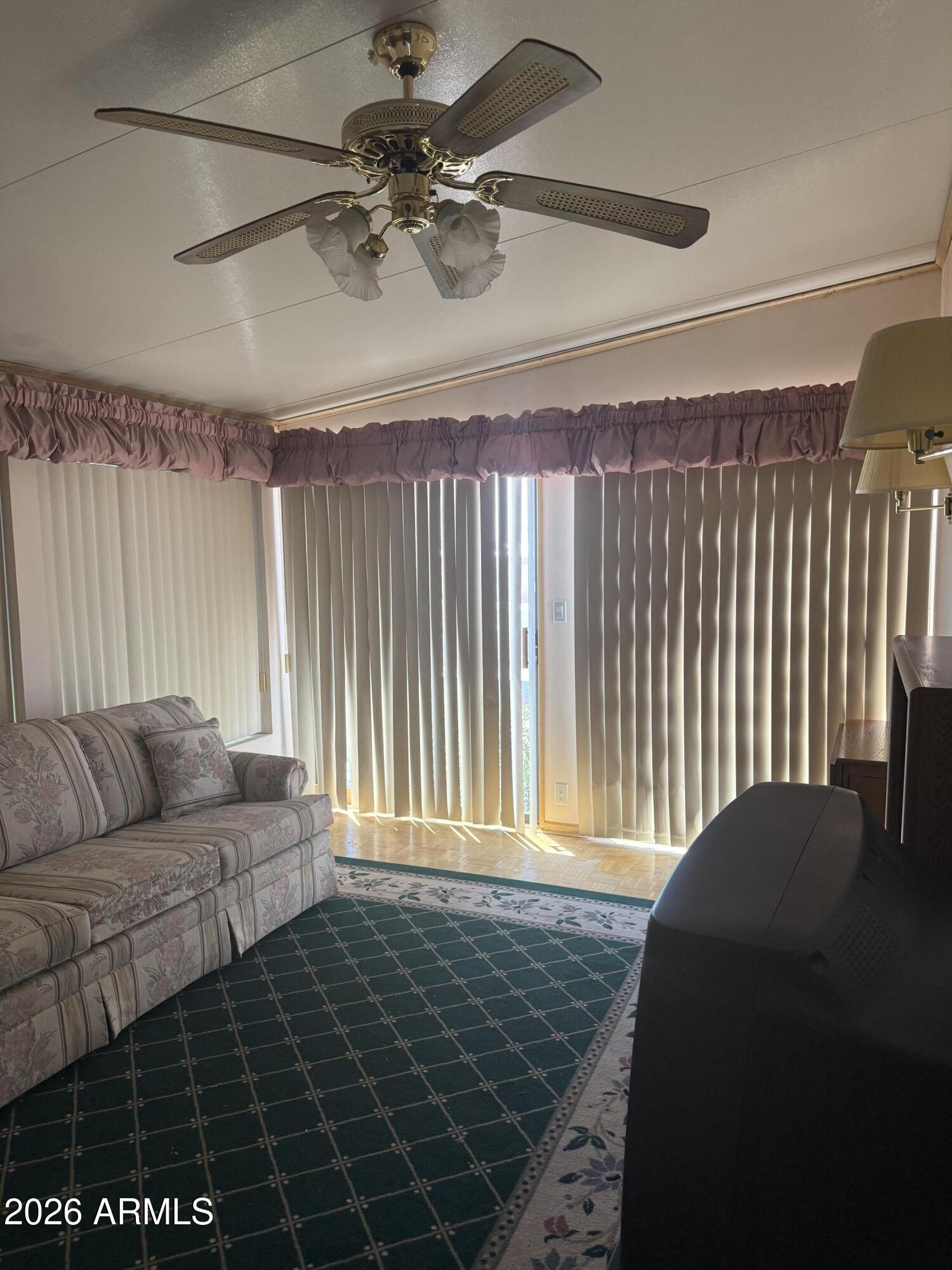 7750 East Broadway Road, Unit 406 Mesa, AZ 85208 - Photo 13 of 36 a living room with furniture and a rug