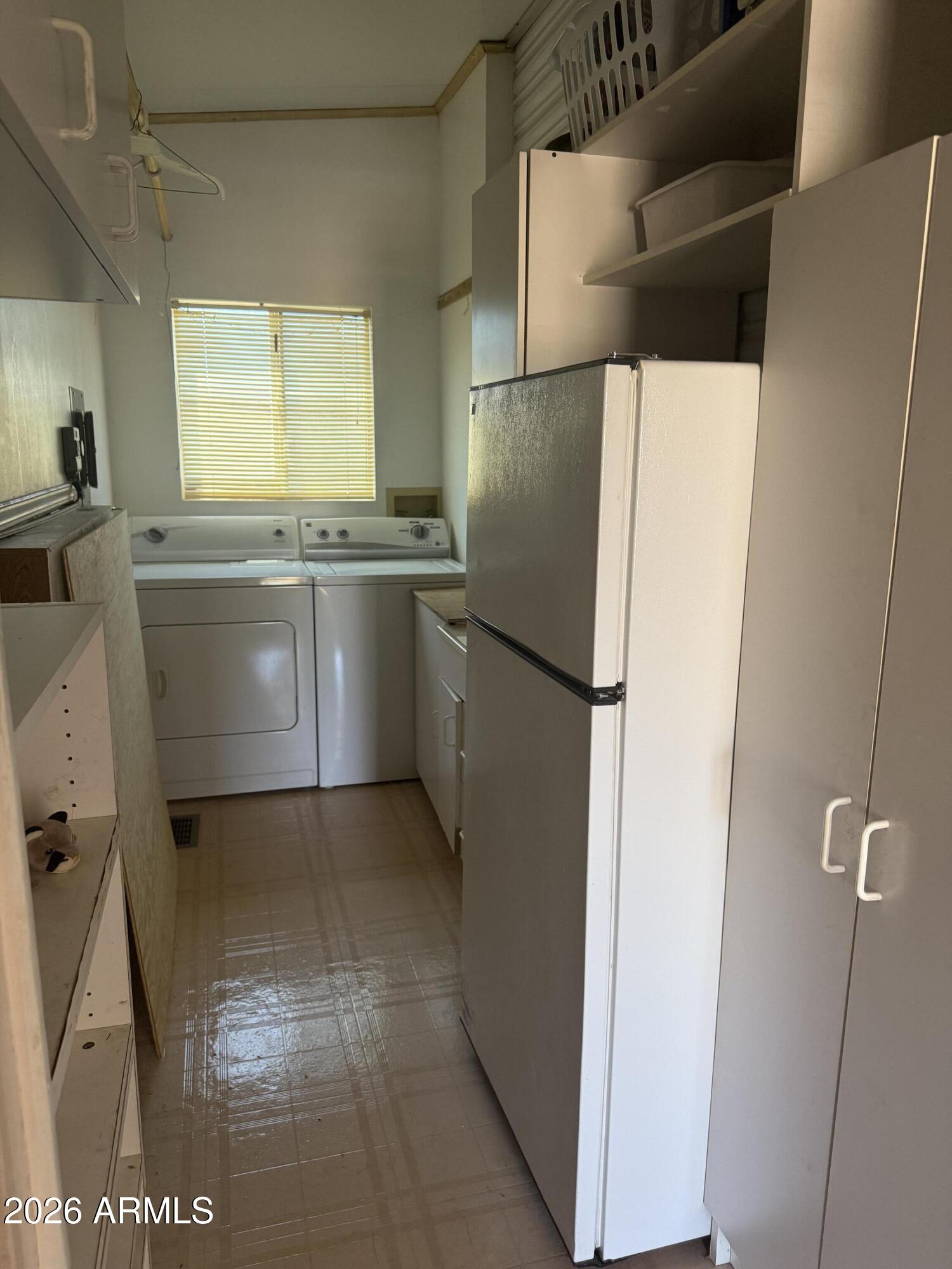 7750 East Broadway Road, Unit 406 Mesa, AZ 85208 - Photo 17 of 36 a kitchen with a refrigerator and cabinets