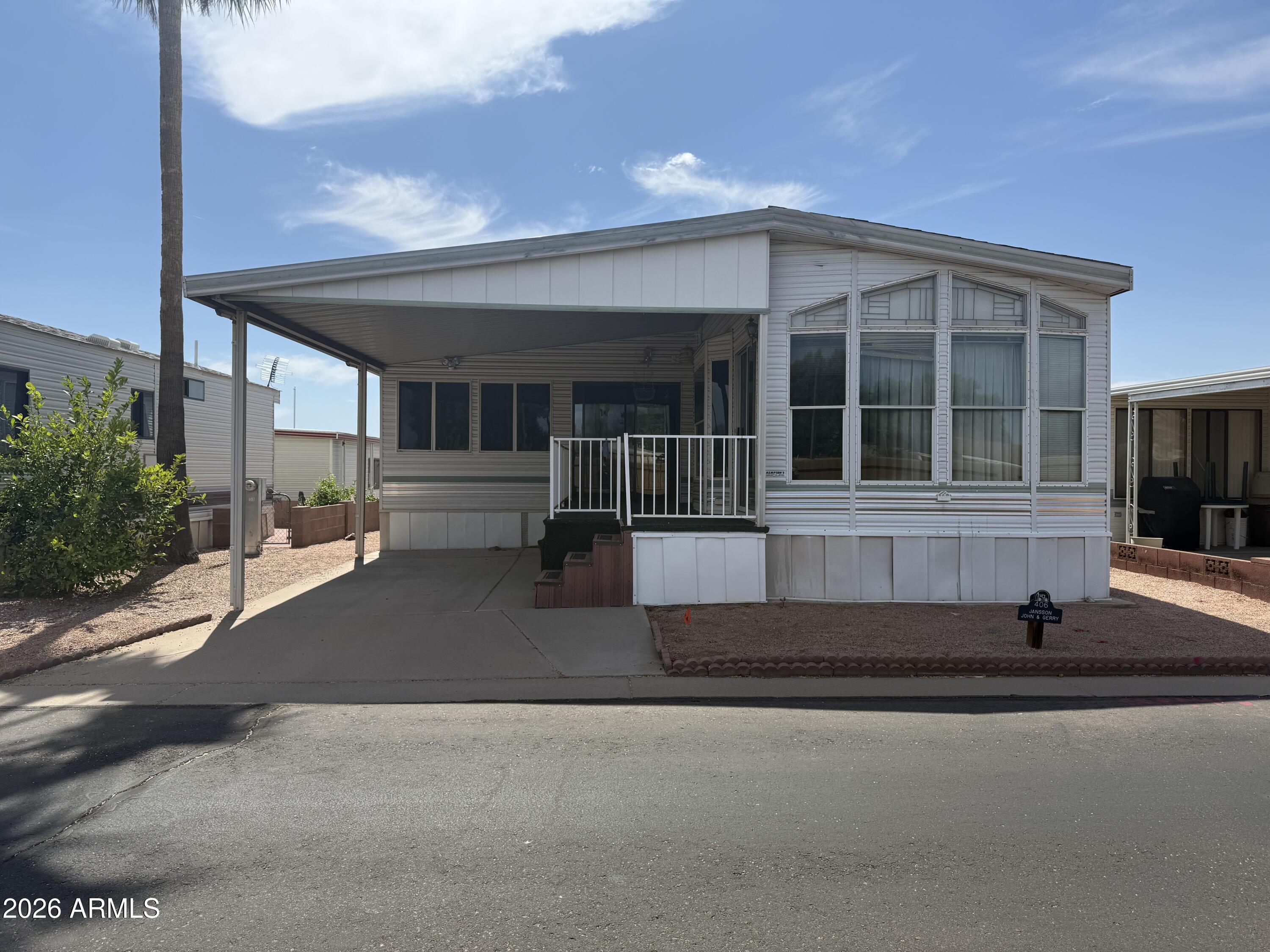7750 East Broadway Road, Unit 406 Mesa, AZ 85208 - Photo 2 of 36 a front view of a house with a garage