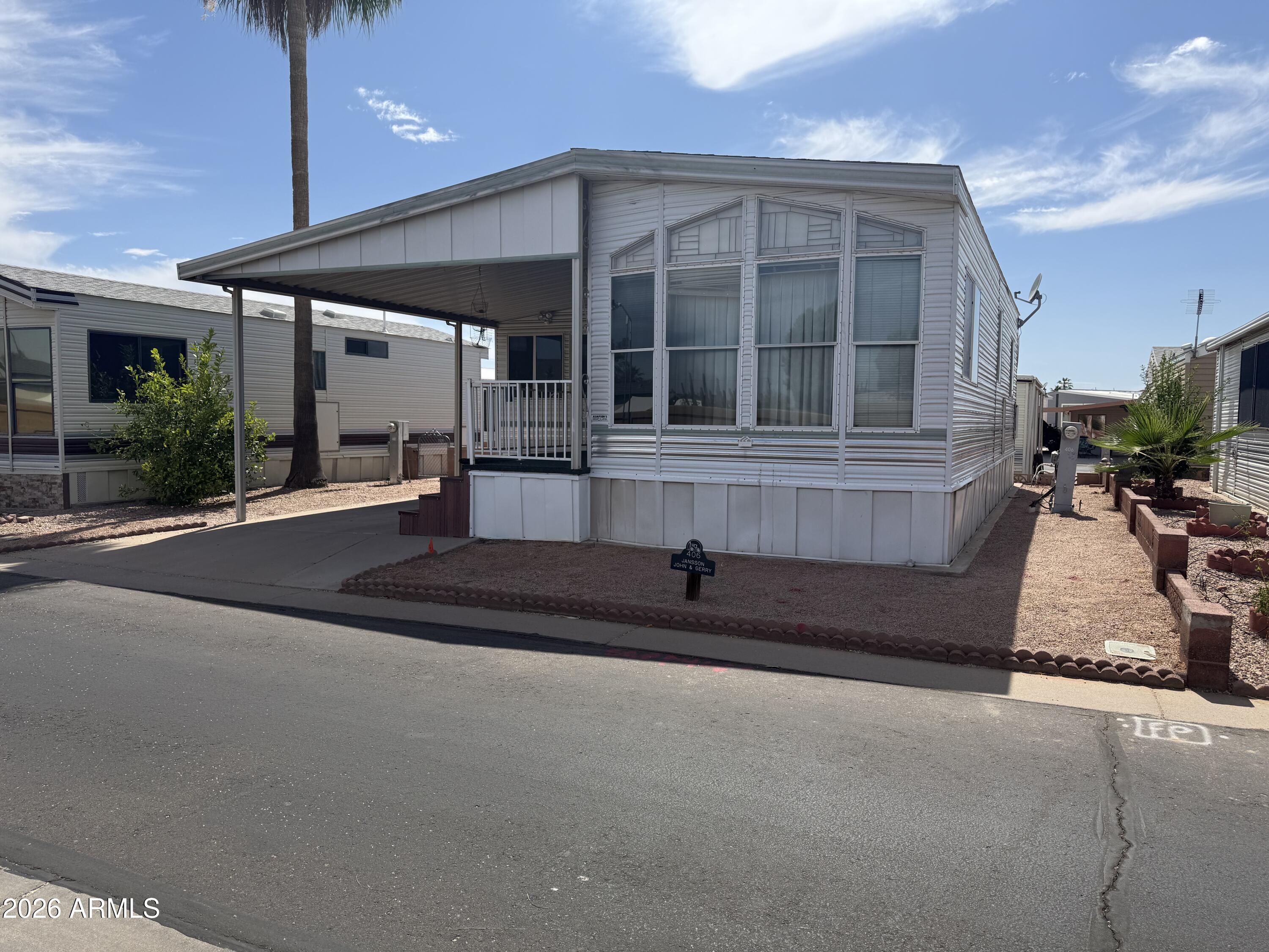7750 East Broadway Road, Unit 406 Mesa, AZ 85208 - Photo 3 of 36 a front view of a house with porch and outdoor seating