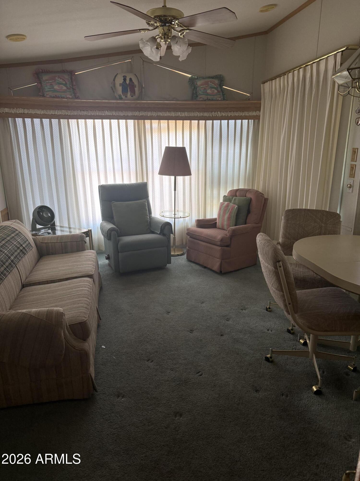 7750 East Broadway Road, Unit 406 Mesa, AZ 85208 - Photo 4 of 36 a living room with furniture and a large window
