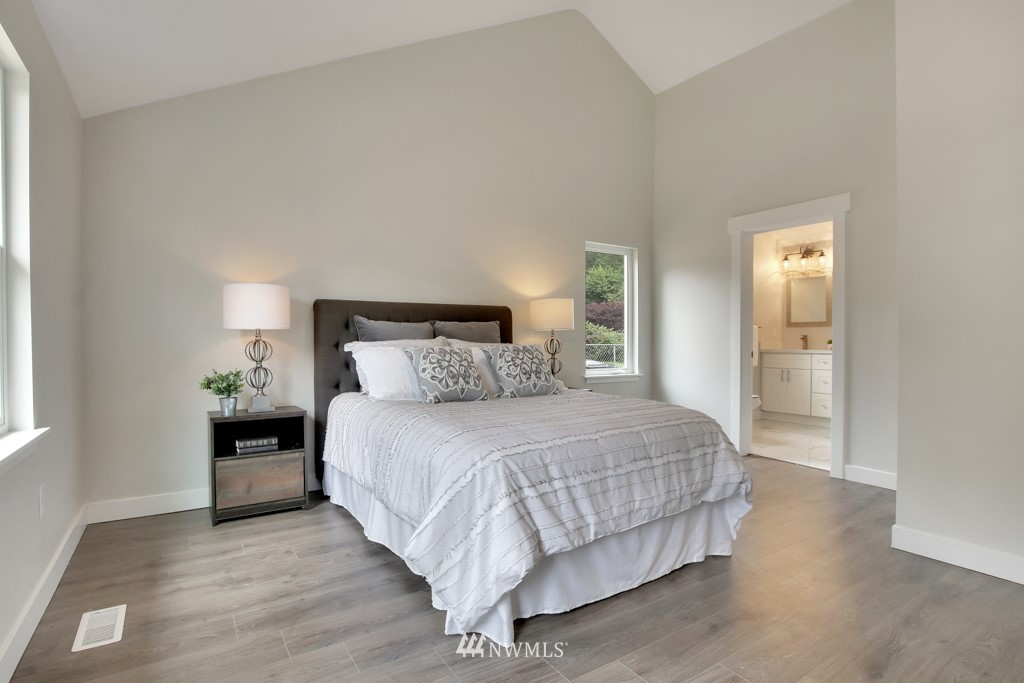 3116 Southeast 6th Street Renton, WA 98058 - Photo 12 of 20 a bedroom with a bed and wooden floor
