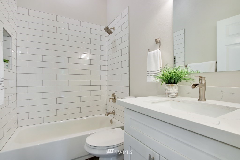 3116 Southeast 6th Street Renton, WA 98058 - Photo 18 of 20 a bathroom with a sink a toilet a mirror and shower