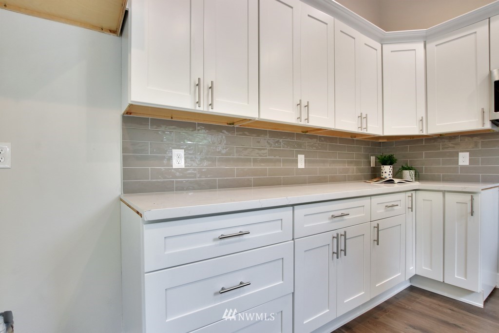 3116 Southeast 6th Street Renton, WA 98058 - Photo 10 of 20 a kitchen with white cabinets and a stove