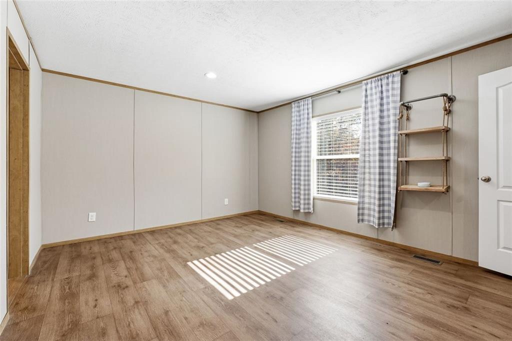 158 Woodsmoke Road Rockmart, GA 30153 - Photo 11 of 25 a view of an empty room with a window and wooden floor