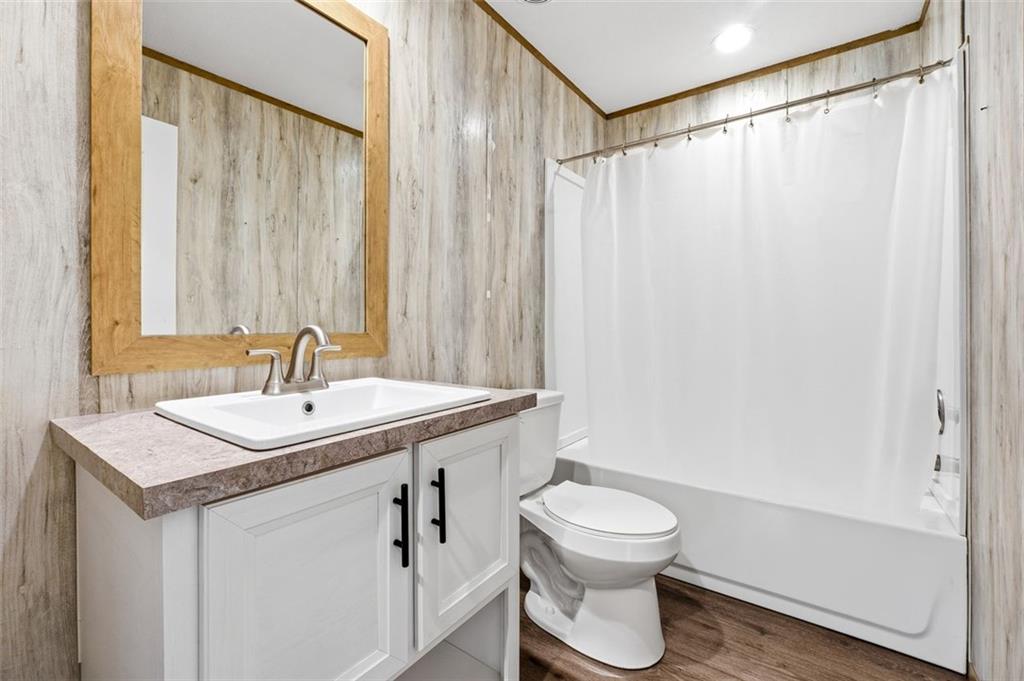 158 Woodsmoke Road Rockmart, GA 30153 - Photo 17 of 25 a bathroom with a sink a toilet and shower curtain