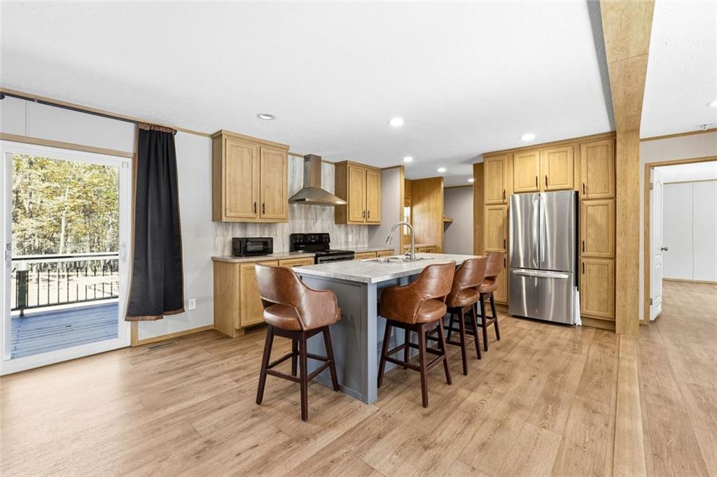 158 Woodsmoke Road Rockmart, GA 30153 - Photo 6 of 25 a kitchen with stainless steel appliances a table chairs refrigerator and cabinets