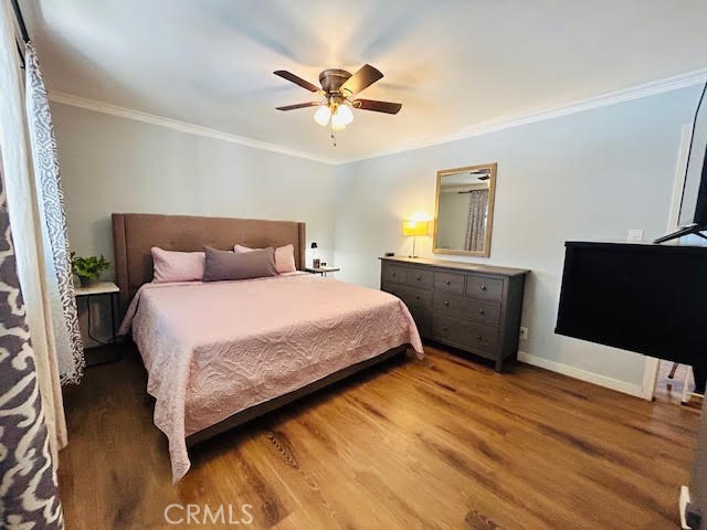 7304 Exeter Street, Unit E Paramount, CA 90723 - Photo 16 of 36 Bright and spacious primary bedroom featuring a window A/C unit and walk-in closet.