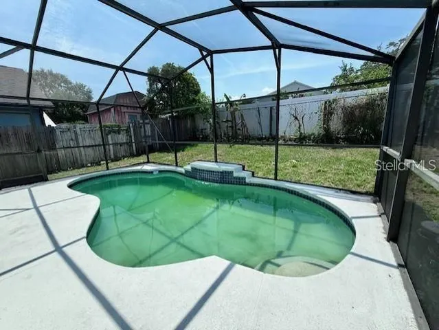a view of a backyard with swimming pool