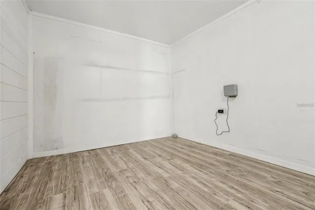 a view of a room with wooden floor