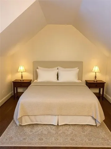 a bedroom with a bed and a night stand