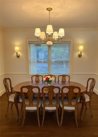 a view of a dining room with furniture and chandelier
