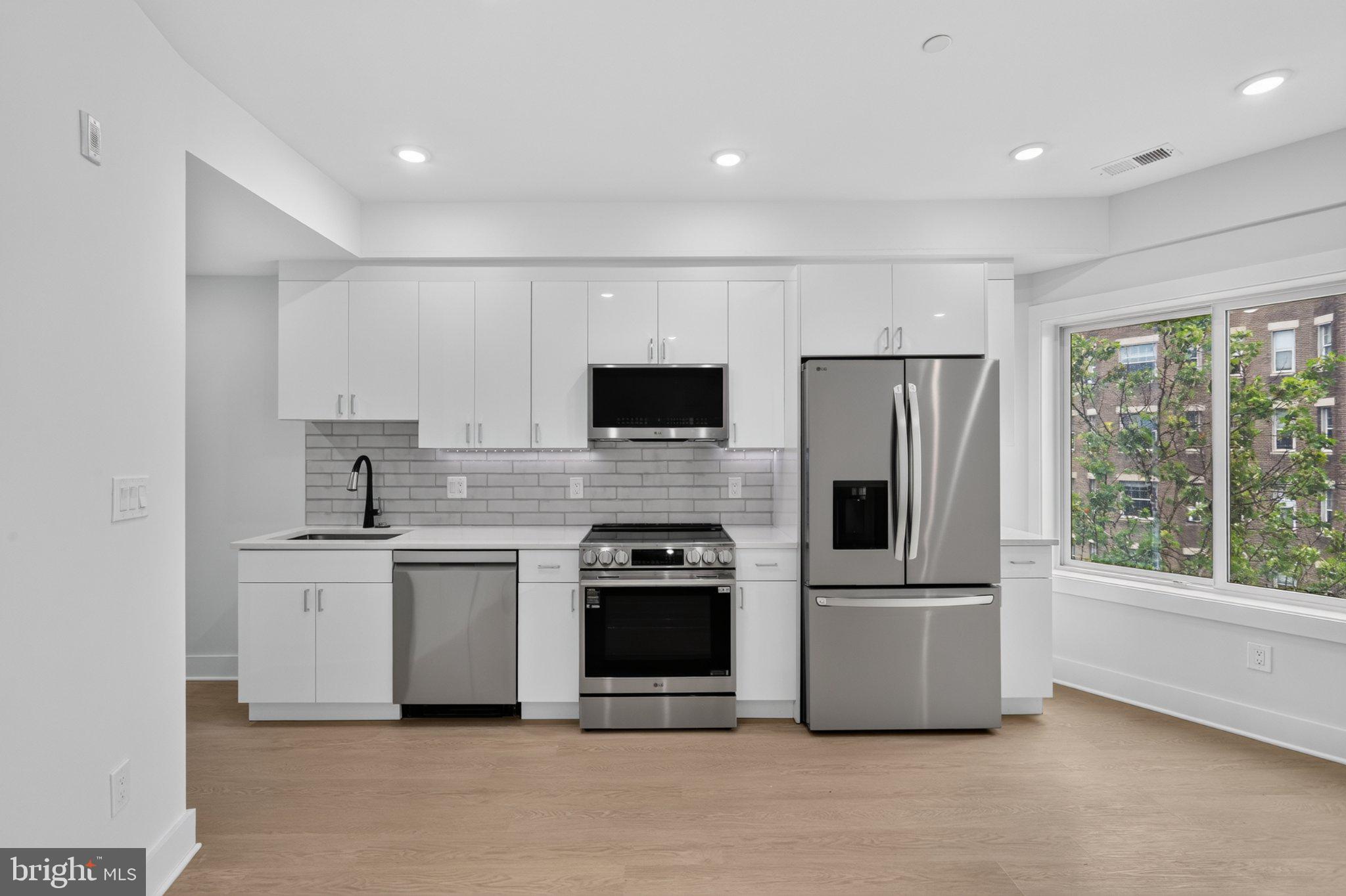 1650 Columbia Road Northwest, Unit 402 Washington, DC 20009 - Photo 5 of 19 Modern kitchen with sleek finishes.