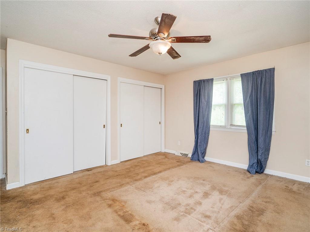 5531 Davis Road Walkertown, NC 27051 - Photo 15 of 30 Primary bedroom with double closets and ceiling fan