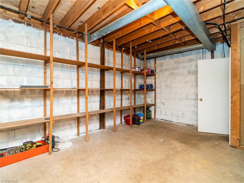 5531 Davis Road Walkertown, NC 27051 - Photo 22 of 30 Unfinished basement with custom shelving