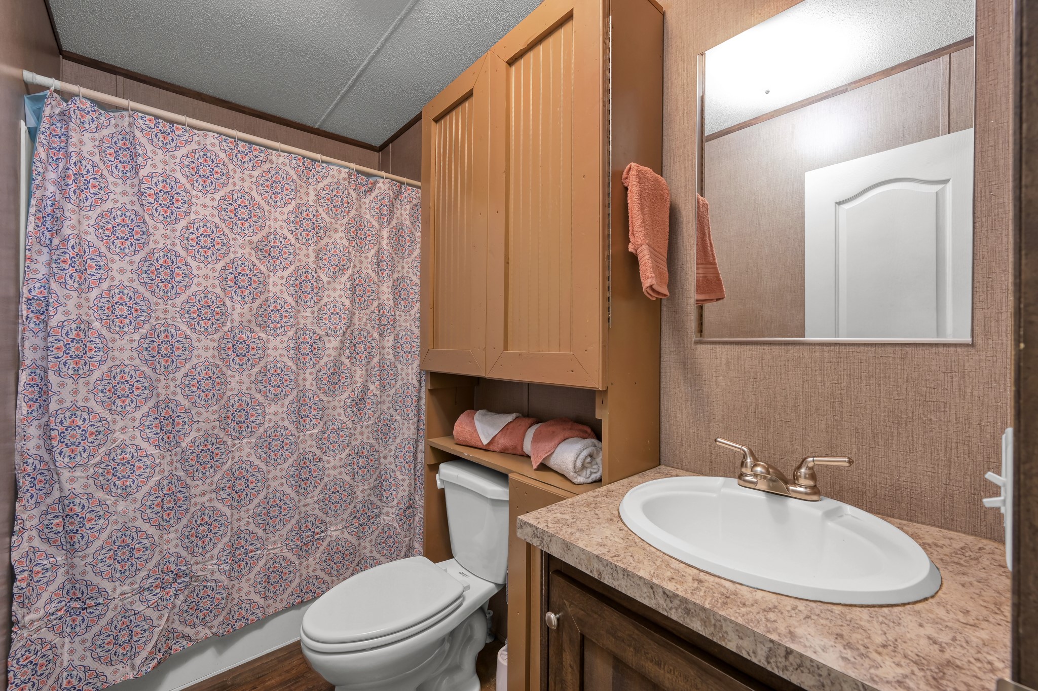 400 Raven Hill Road Oakhurst, TX 77359 - Photo 28 of 45 a bathroom with a granite countertop sink a toilet and a mirror