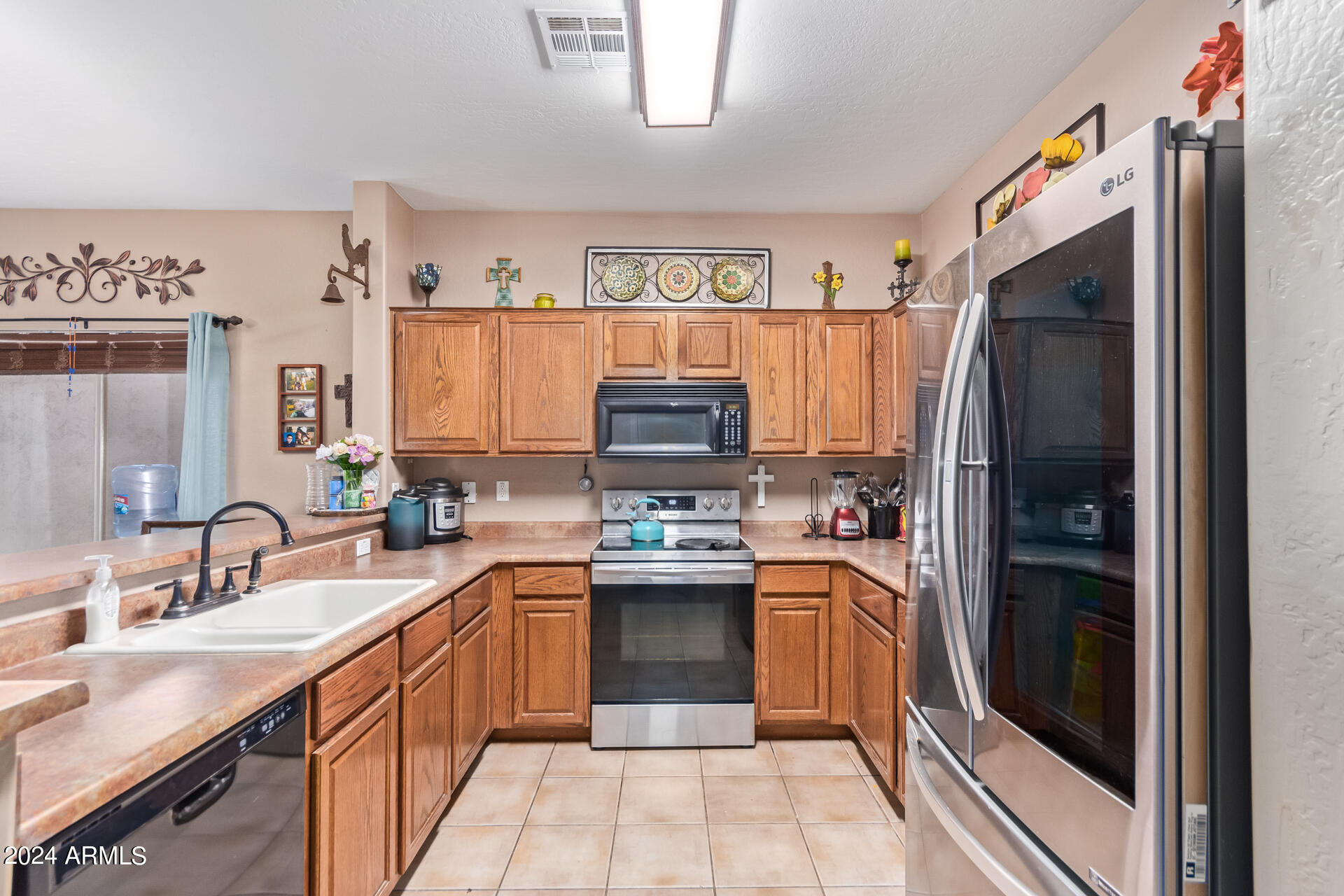 321 East Cheyenne Road San Tan Valley, AZ 85143 - Photo 17 of 33 a kitchen with stainless steel appliances granite countertop a refrigerator stove and sink