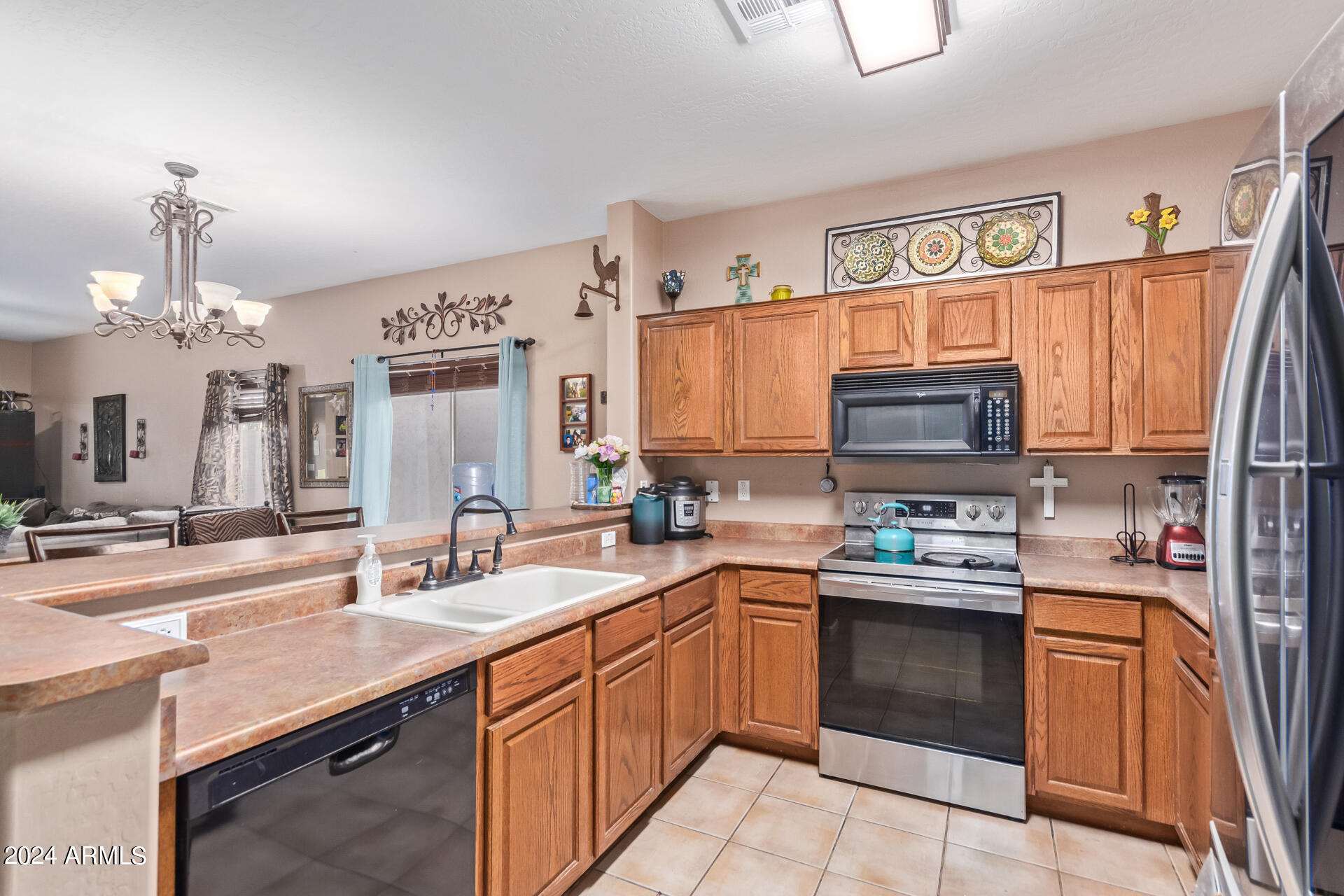 321 East Cheyenne Road San Tan Valley, AZ 85143 - Photo 18 of 33 a kitchen with kitchen island granite countertop a sink dishwasher stove top oven and cabinets