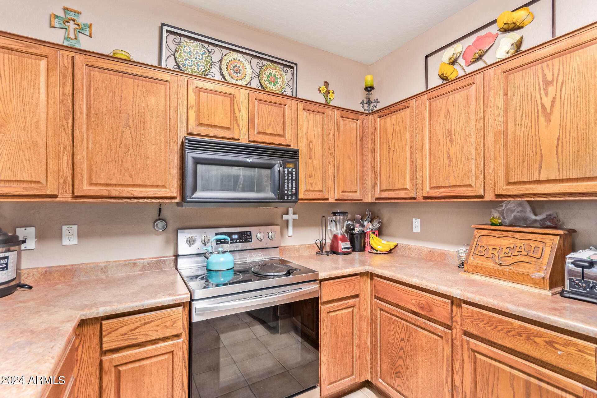 321 East Cheyenne Road San Tan Valley, AZ 85143 - Photo 19 of 33 a kitchen with stainless steel appliances granite countertop a sink a stove cabinets and a microwave oven