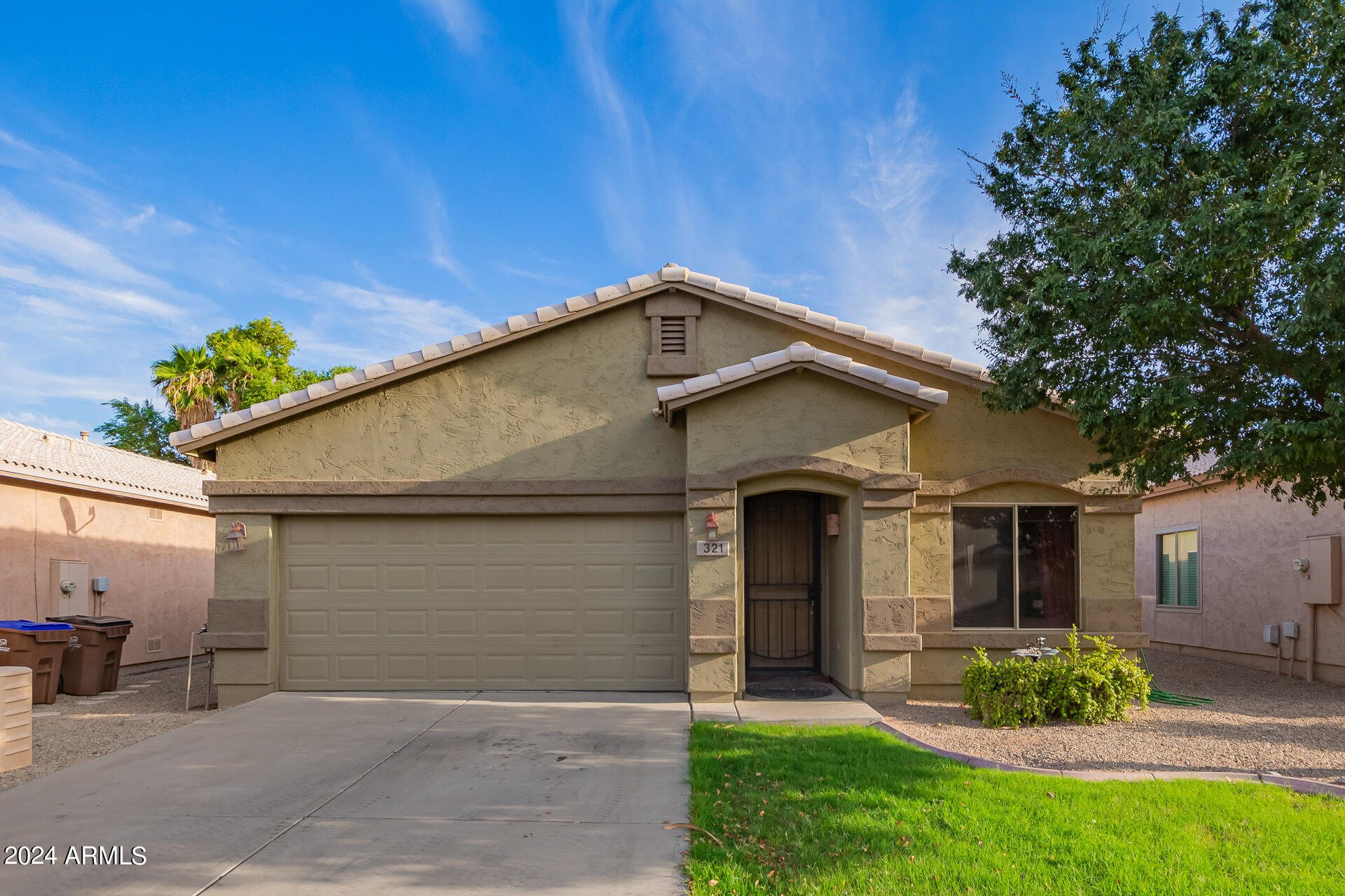 321 East Cheyenne Road San Tan Valley, AZ 85143 - Photo 2 of 33 a front view of a house with a yard and garage