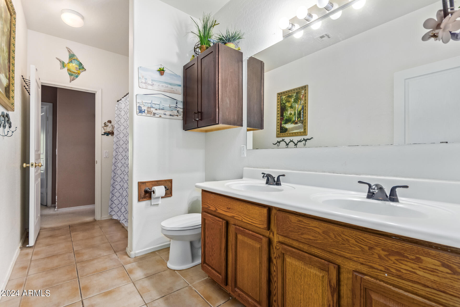 321 East Cheyenne Road San Tan Valley, AZ 85143 - Photo 27 of 33 a bathroom with a sink a toilet and mirror