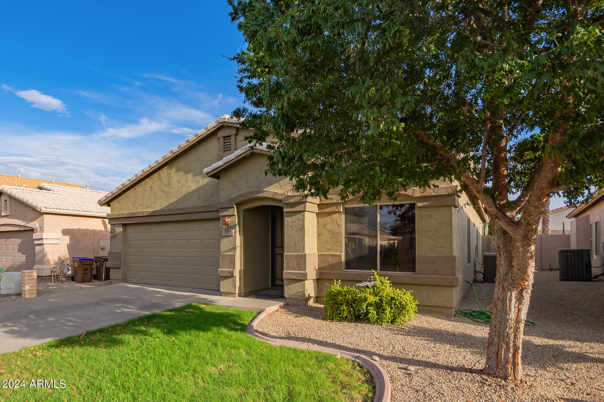 321 East Cheyenne Road San Tan Valley, AZ 85143 - Photo 6 of 33 a front view of a house with garden