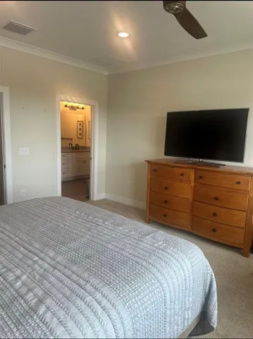 a bedroom with a bed and a lamp on the dresser
