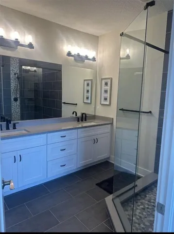 a bathroom with a glass door shower