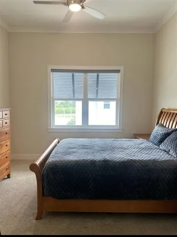 a large bed sitting in a bedroom next to a window