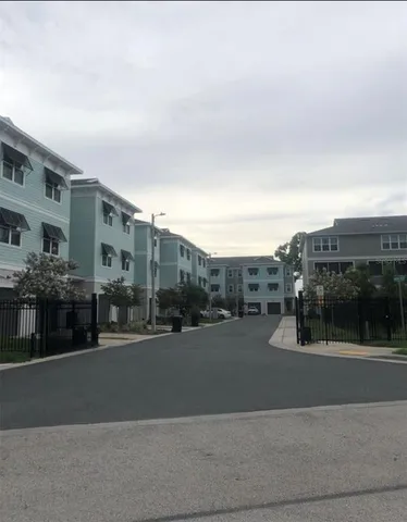 a large kitchen with a table chairs and wooden floor