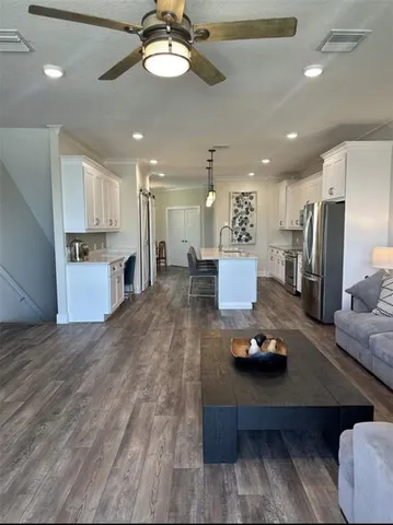 a view of a dining room with furniture wooden floor and chandelier