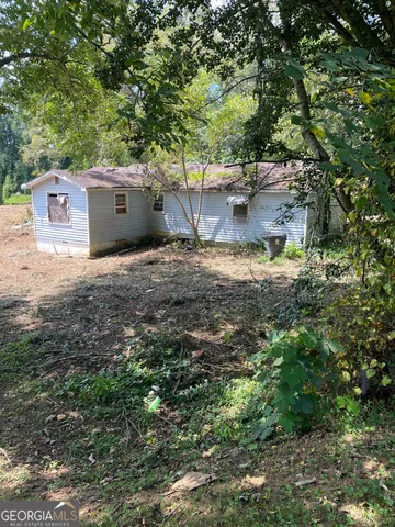 a backyard of a house with oven and tree