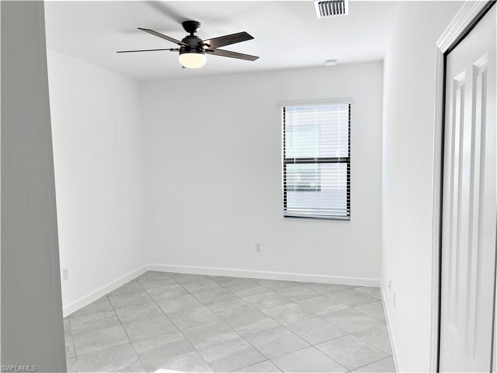 11163 Canopy Loop Fort Myers, FL 33913 - Photo 13 of 16 Empty room featuring ceiling fan and light tile patterned floors
