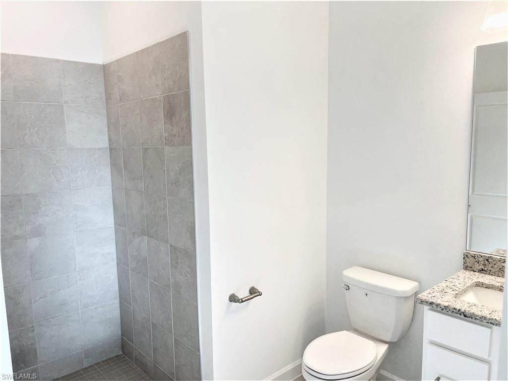 11163 Canopy Loop Fort Myers, FL 33913 - Photo 14 of 16 Full bathroom with vanity and a tile shower