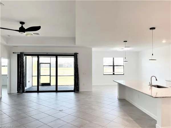 a large white kitchen with a large window