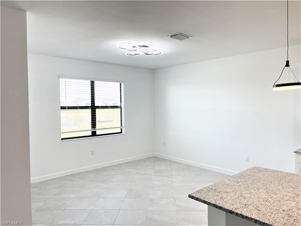 11163 Canopy Loop Fort Myers, FL 33913 - Photo 5 of 16 Unfurnished dining area featuring baseboards and light tile patterned floors