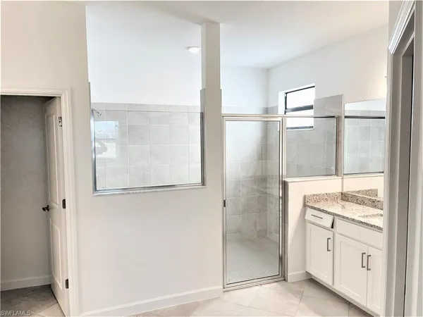 a bathroom with a shower and a mirror