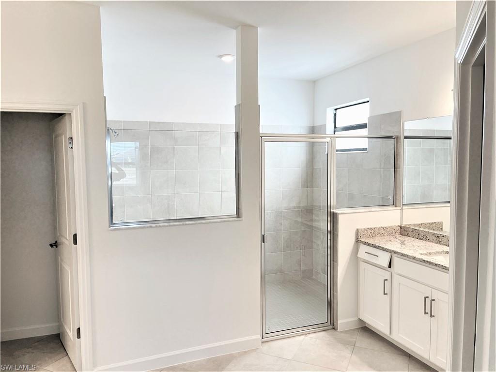 11163 Canopy Loop Fort Myers, FL 33913 - Photo 8 of 16 Full bath with a shower stall, vanity, and light tile patterned floors