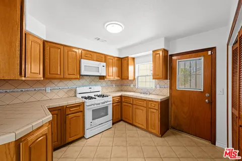 a kitchen with stainless steel appliances granite countertop a stove sink and cabinets
