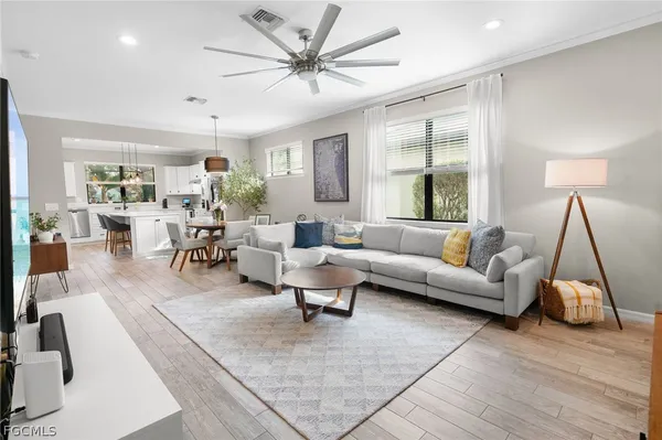 a living room with furniture and wooden floor