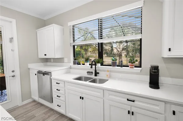 a kitchen with a sink and large window