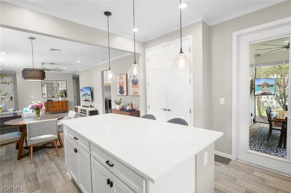 a large white kitchen with a large window