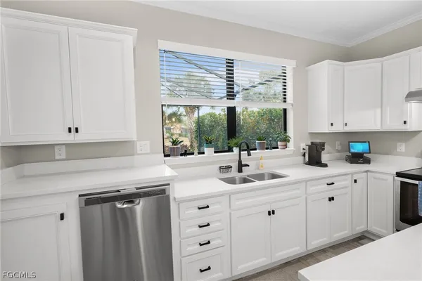 a kitchen with granite countertop white cabinets white appliances and sink