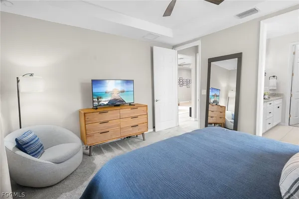 a bedroom with furniture and a flat screen tv