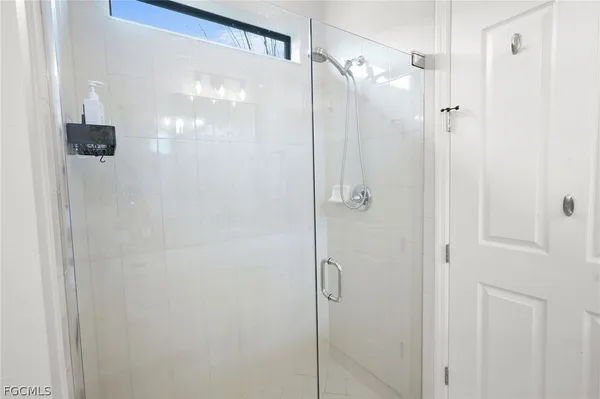 a bathroom with a glass shower door