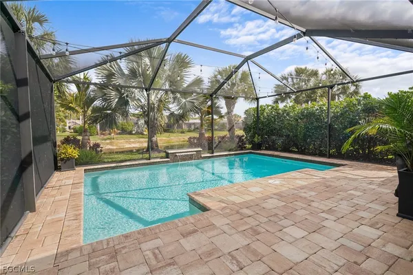 a view of a backyard with a swimming pool